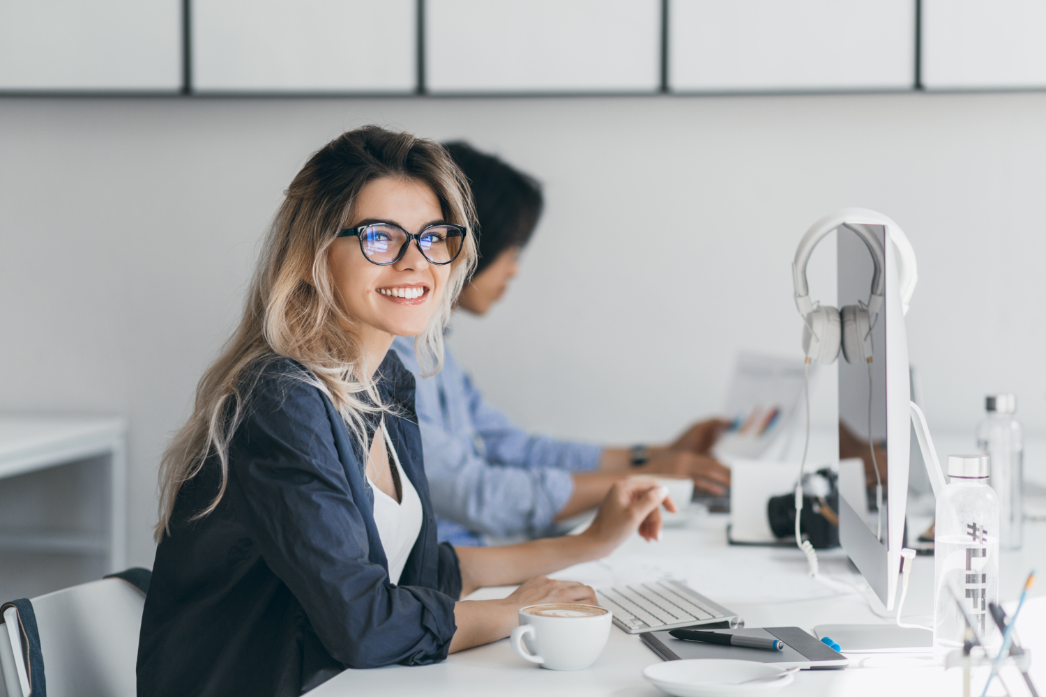 attractive-laughing-freelancer-woman-posing-with-cup-coffee-her-workplace-chinese-student-blue-shirt-works-with-document-campus-with-blonde-friend-glasses1